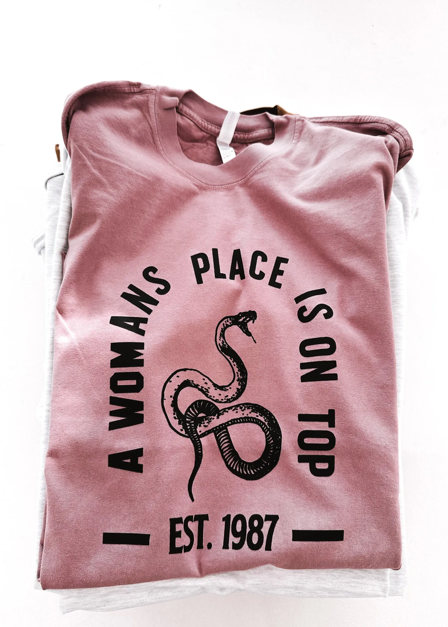 A WOMAN'S PLACE IS ON TOP SIDE SLIT TEE